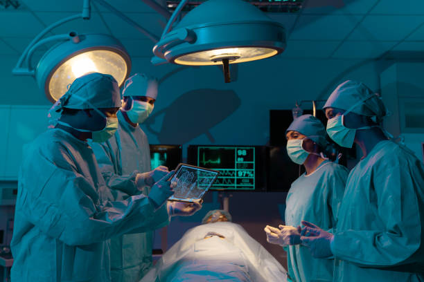 istock Medical Team Performing Surgical Operation in Modern Operating Room. 1600469744
