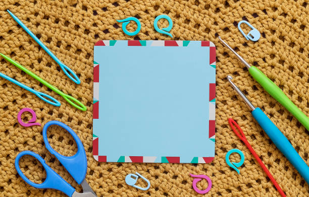 istock Blue empty card with colorful crochet tools on a crochet background. Top view. Copy space. 1600485503