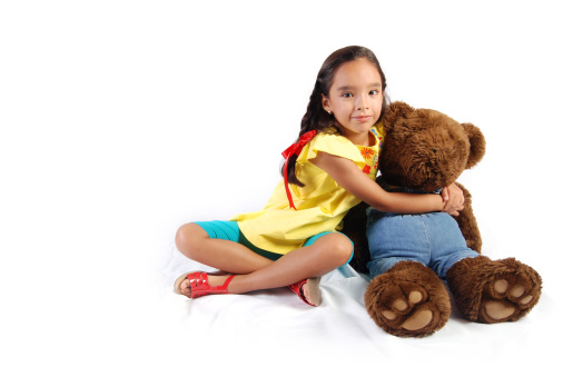 Beautiful girl hugging her teddy bear