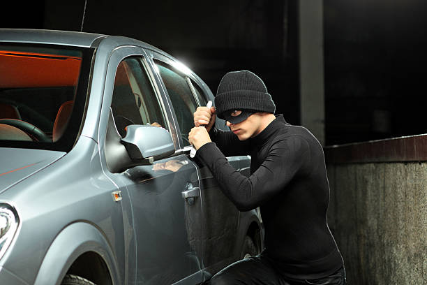 istock Thief with a mask trying to steal an automobile 160049982