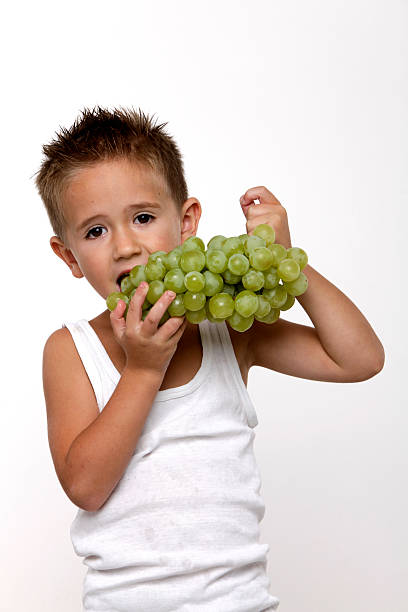 istock little boy is eating the grape XXXL 160050189