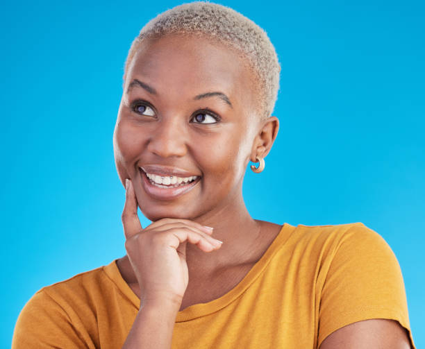 istock Thinking, smile and black woman with ideas, decision and problem solving on a blue studio background. Person, choice or model with happiness, inspiration and brainstorming with planning and emoji 1600507654