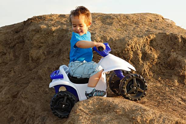 istock Boy driving toy quad on terrain 160051079