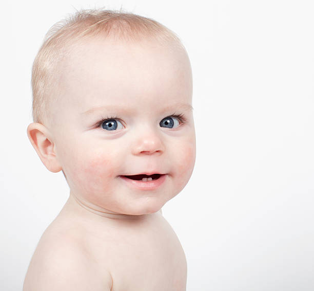 Smiling baby boy looking at camera stock photo