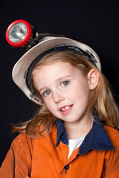 istock Young Child in Coal Miner Hat and Safety Clothing 160051414