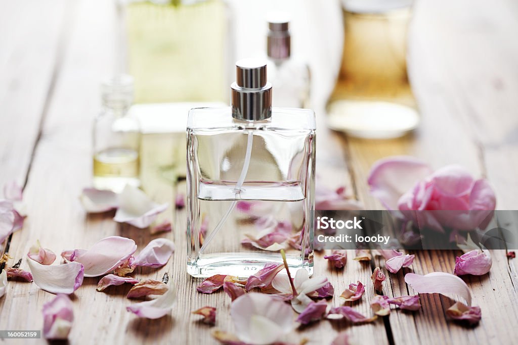 perfume selection of perfume bottles surrounded by flower petals Perfume Stock Photo