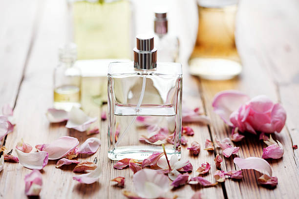 perfume selection of perfume bottles surrounded by flower petals scented stock pictures, royalty-free photos & images