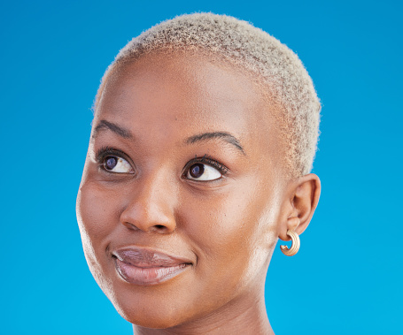 Black woman, headshot and thinking with inspiration, decision and ideas isolated on blue background. Female person, African and question with vision, future and remember with dream in a studio