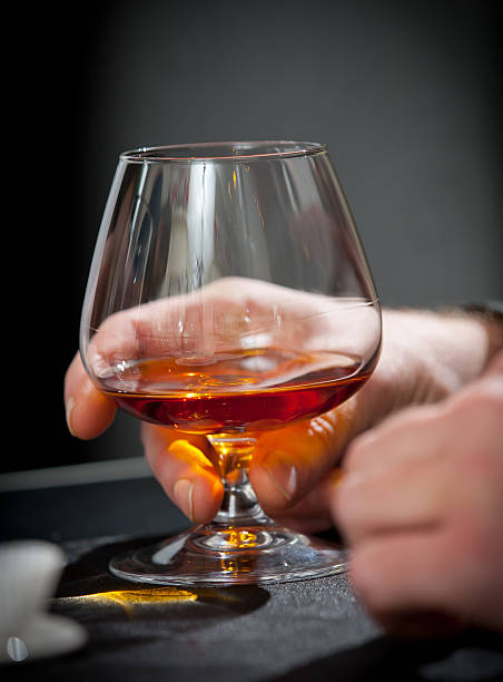 istock Hand with glass of cognac 160052438