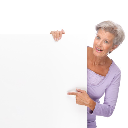 Full isolated portrait of a beautiful and happy senior woman with blank sign