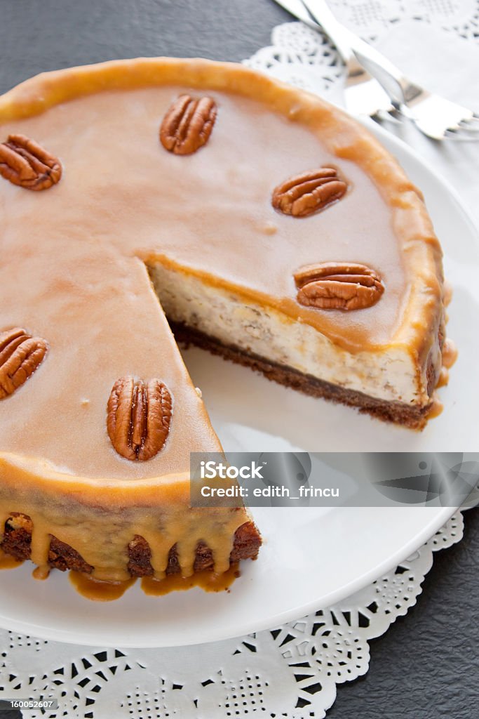 Caramel cheesecake Caramel cheesecake with pecan nuts on a white plate Baked Stock Photo