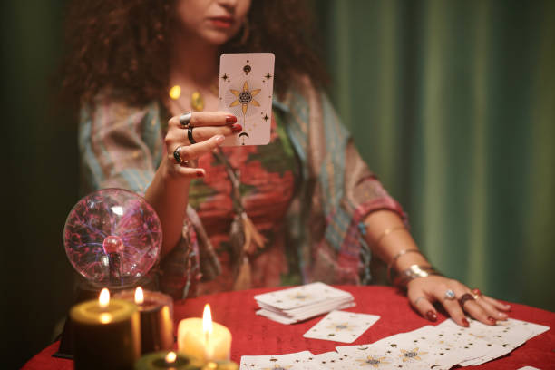istock Cropped image of witch taking major arcana, tarot card from table 1600527310