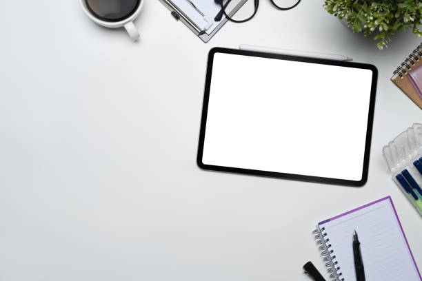 istock White office desk with digital tablet, keyboard and notepad. Flat lay, top view with copy space 1600529053
