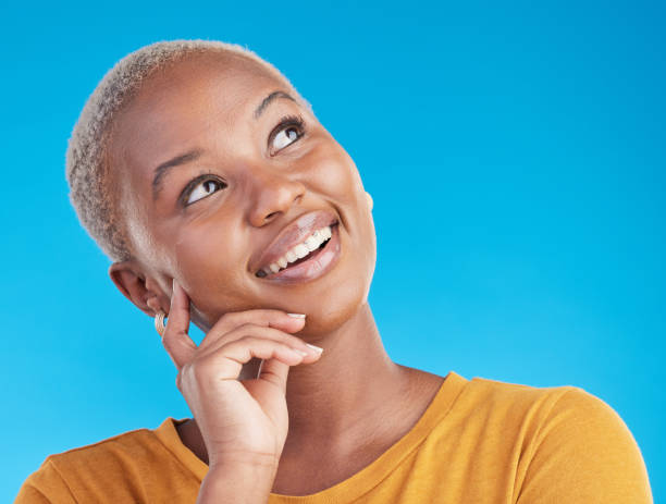 istock Thinking, smile and black woman with ideas, opportunity and solution on a blue studio background. Person, girl or model with problem solving, thoughts and decision with happiness, choice and planning 1600529255