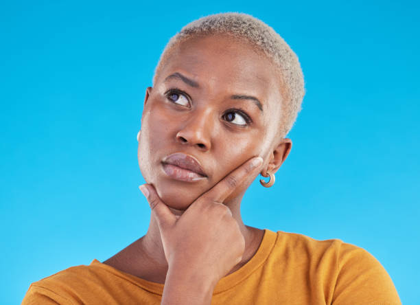 istock Thinking, decision and black woman with ideas, opportunity and planning on a blue studio background. Person, girl and model with problem solving, solution and question with choice and mockup space 1600529568