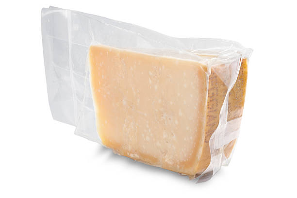 Vacuum-packed parmesan cheese Slice of italian Parmesan cheese (parmiggiano reggiano) vacuum-packed - isolated on white with clipping path vacuum packed stock pictures, royalty-free photos & images