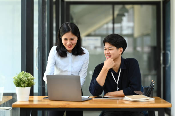 istock Smiling female manager explaining information, discussing business plan with businessman 1600530677