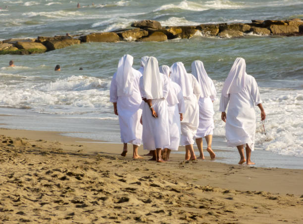 istock Nuns walk in the sand on the italia beach 1600535628