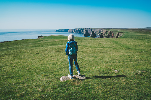Woman, just looking,  at Duncansby Head near John o’Groats on the north east tip of the Scottish mainland.