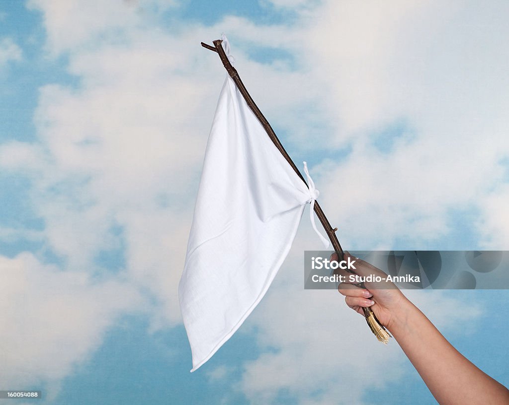 White flag Clouds and female hand waving with a white flag to surrender Raise the White Flag Stock Photo