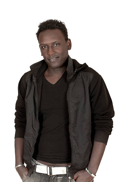 istock dark-skinned young man standing hands in pockets 160054209