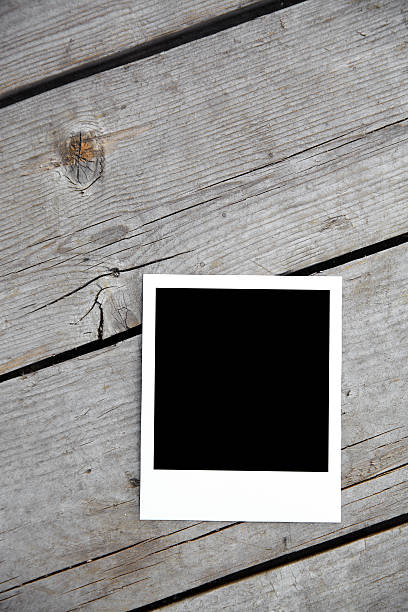istock Blank instant photo on old wooden background. 160054545