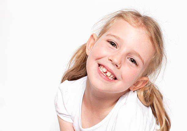 Happy young girl looking at camera and smiling stock photo