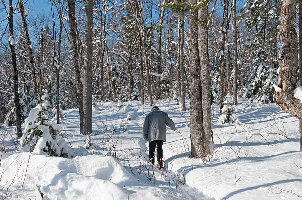 active senior with snowshoes stock photo