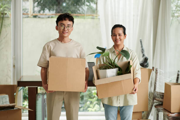 istock Cheerful Husband and Wife with Cardboard Boxes 1600548892