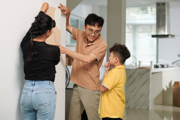 istock Family Hanging Picture on Wall 1600549474