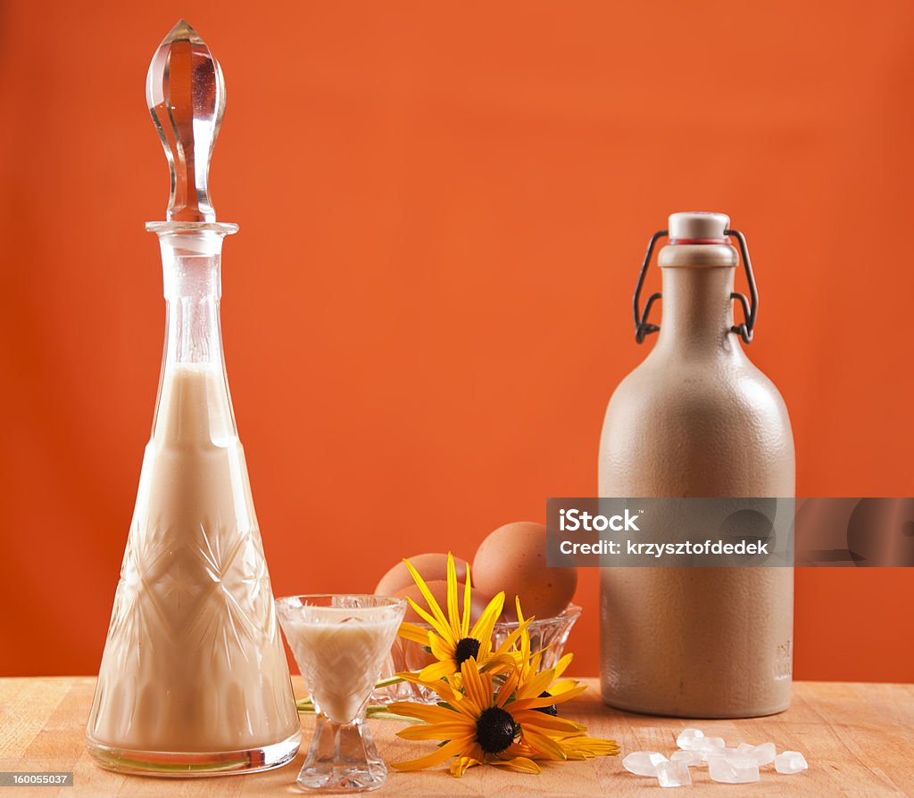 glass of eggnog glass of eggnog with carafe on orange background Alcohol - Drink Stock Photo