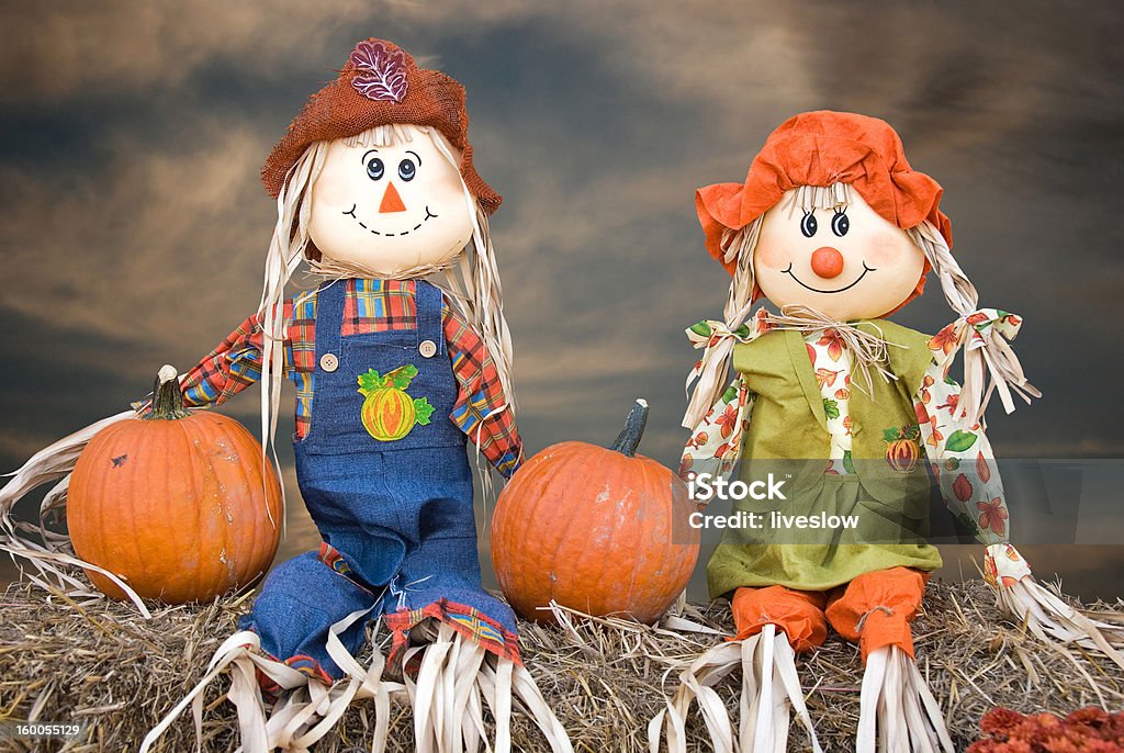 scarecrow couple Autumn scarecrow couple sitting on hay bales. Autumn Stock Photo