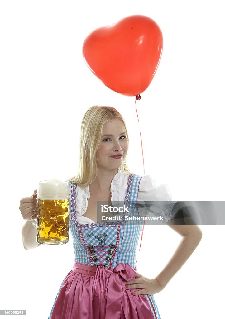 Woman in Dirndl with Balloon Woman in Dirndl with red heart Balloon Cleavage - Breasts Stock Photo