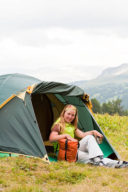 istock girl has a rest in green tent 160055431