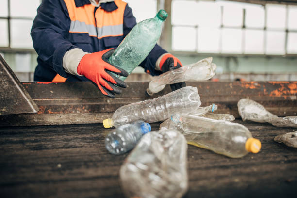istock Group of workers at the recycling centre sorting plastic waste ad preparing for recycling 1600558777