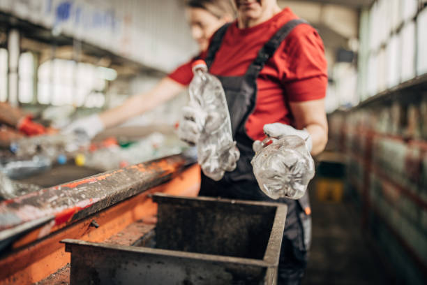 istock Group of workers at the recycling centre sorting plastic waste ad preparing for recycling 1600560427