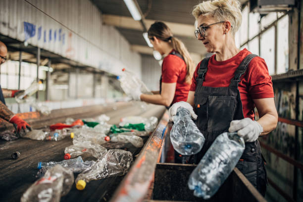 istock Group of workers at the recycling centre sorting plastic waste ad preparing for recycling 1600562681