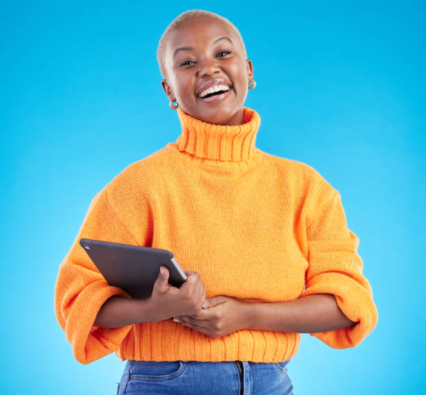 istock Portrait, happy or black woman in studio with tablet for schedule planning on blue background. Internet, face or confident African entrepreneur with technology for online review, news or feedback 1600566647