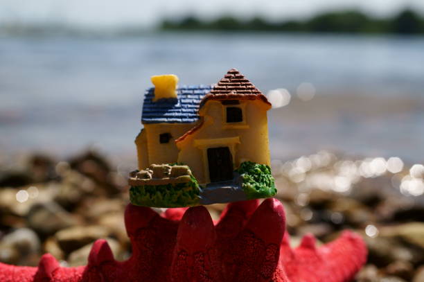 istock A seashell and a toy house. 1600567258