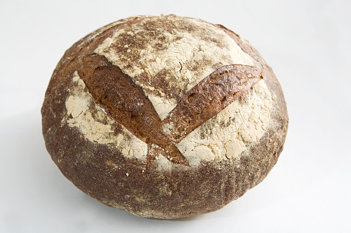 cleanly lit sharp shot of a round rustic loaf of german bread (miche).