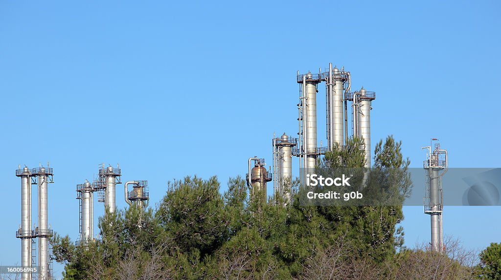 Oil Refinery Many towers in an oil refinery over blue sky Air Pollution Stock Photo