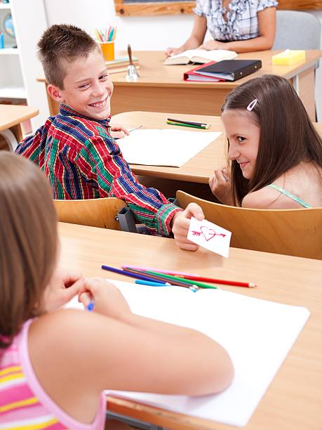 istock Elementary school boy giving love letter to his colleague 160057029