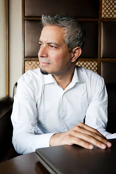 Photo of portrait of a handsome indian businessman with grey hair