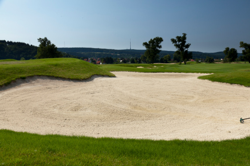 sand bunker on  a beautiful golf coursesand bunker on  a beautiful golf course
