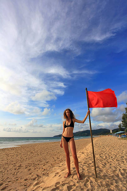 istock woman with red flag 160057323