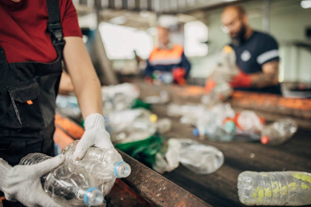 istock Group of workers at the recycling centre sorting plastic waste ad preparing for recycling 1600575627