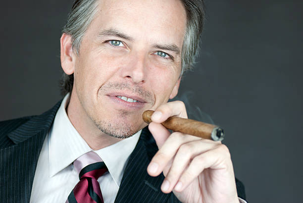 istock Successful Businessman Smokes Cigar 160058484