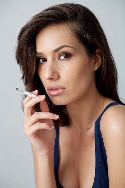Portrait of Young Woman with Cigarette Serious Expression stock photo