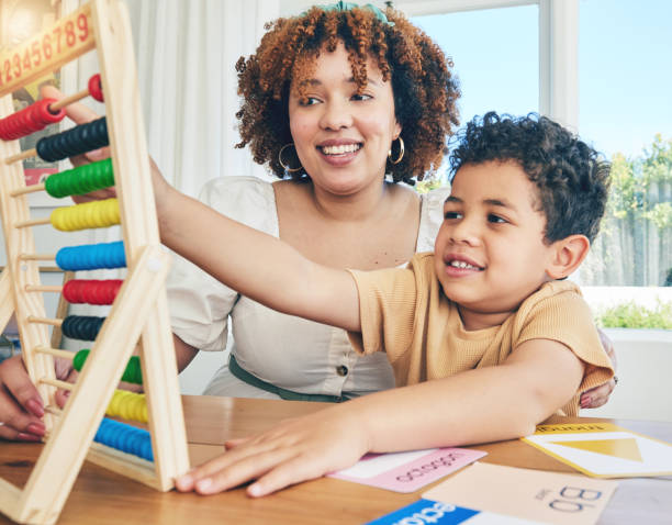 istock Learning, abacus and education with mother with son study for home schooling, kindergarten and tutor. Teaching, child development and lesson with black woman and child for colorful, math or creative 1600587351