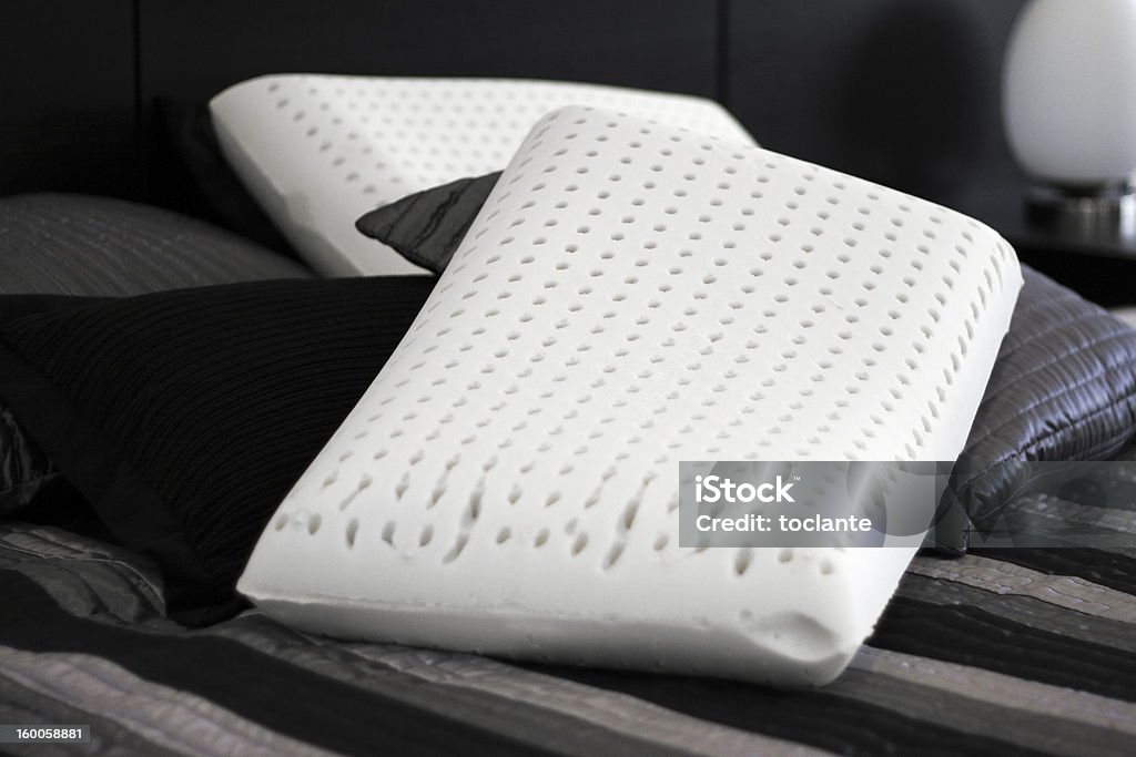 Latex pillows. Two ergonomic pure latex on satin sheets. Latex Stock Photo